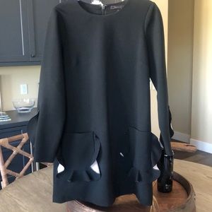 Black dress with with light pocket accents.